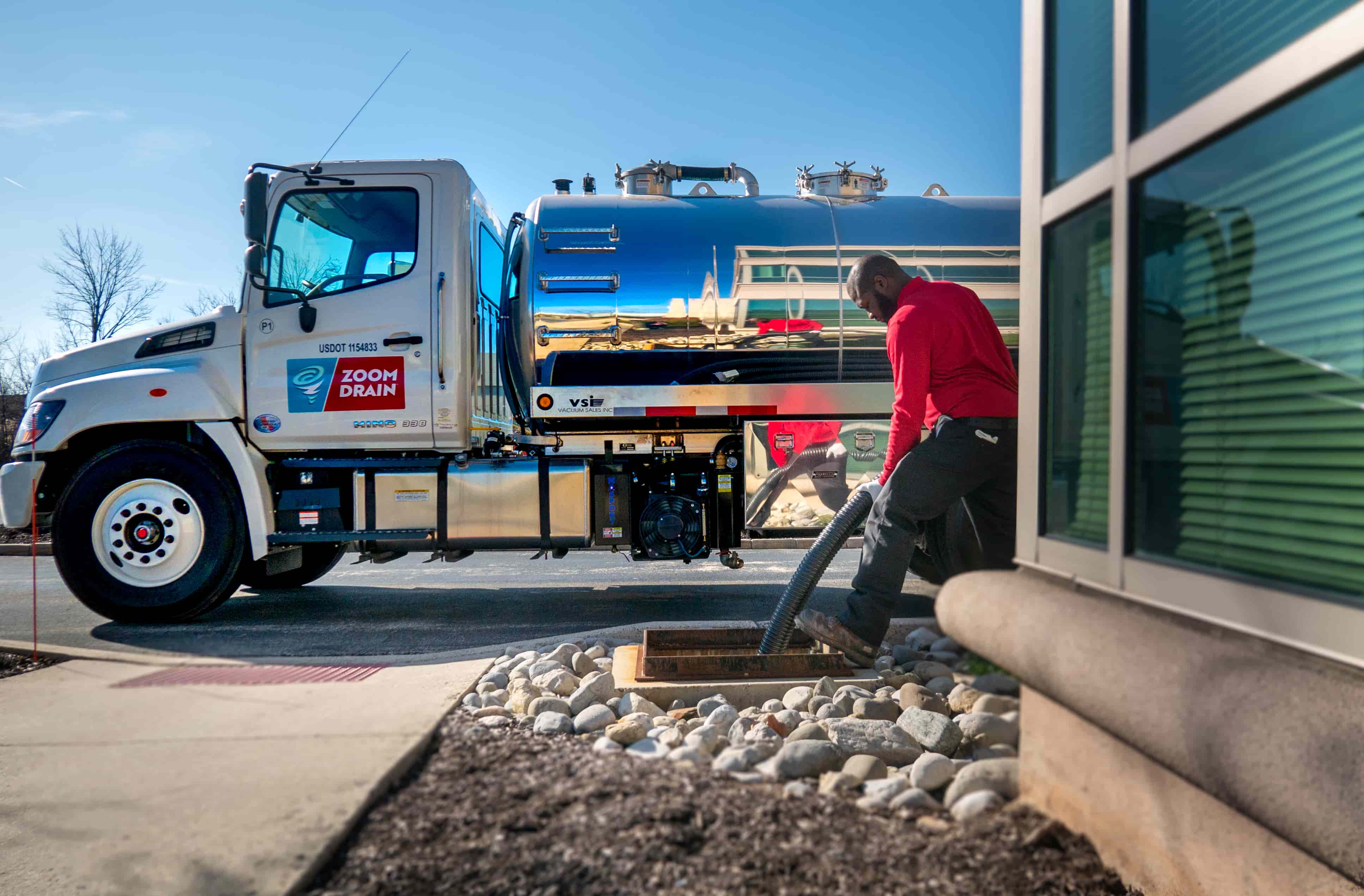 zoom drain employee doing a commercial pumping service