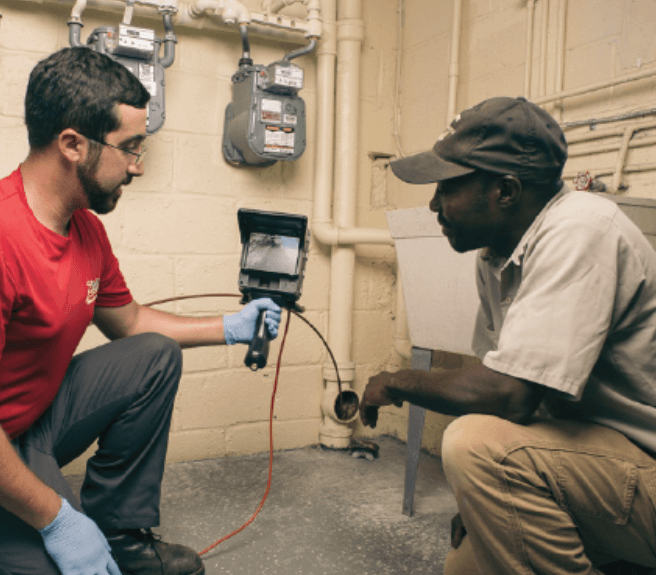 A Zoom Drain technician holds a sewer inspection camera